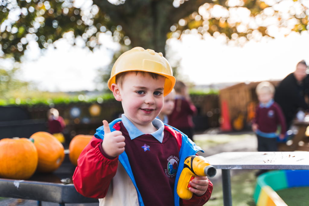 Reception pupil wearing hard hat