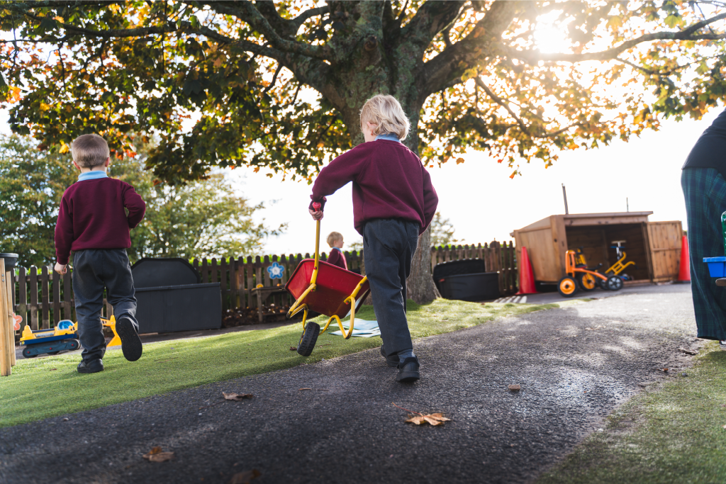 Reception pupil with play wheelbarrow